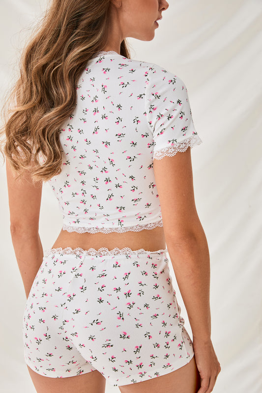 Back view of white floral crop top and matching sleep shorts