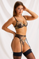 Side view of black floral lingerie showing sheer mesh, a thong cut and adjustable garter straps