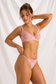 Angled view of pink floral lace bra and matching thong showing sheer fabric and ruffled edges