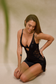Model wearing black satin lingerie dress