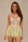 Model wearing pastel yellow lace babydoll lingerie smiling