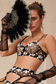 model playfully covering face with feathered fan in black lingerie set