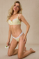 model kneeling in yellow gingham bra and thong set holding a white flower