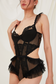 model wearing black rococo-inspired sheer lace lingerie bodysuit

