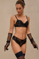 Model wearing elegant black lingerie with sequins